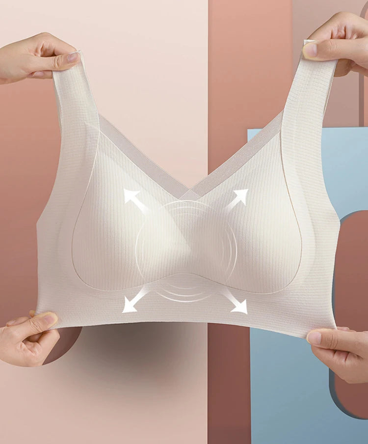 Beige bra held up against a multicolored background