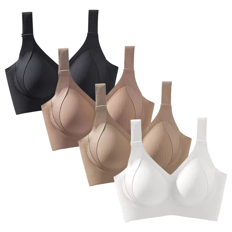 Set of black, beige, and white bras on a white background