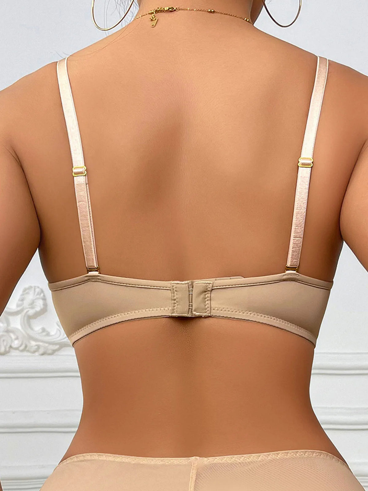 Beige bra on a mannequin against a white background