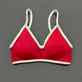 Red bra with white straps on a gray background