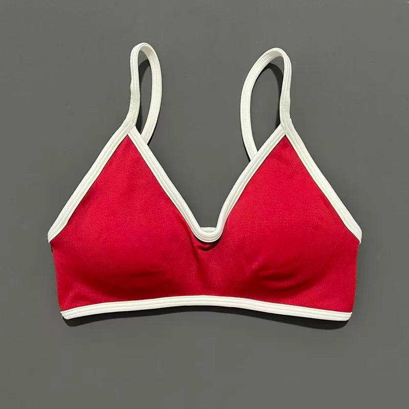Red bra with white straps on a gray background