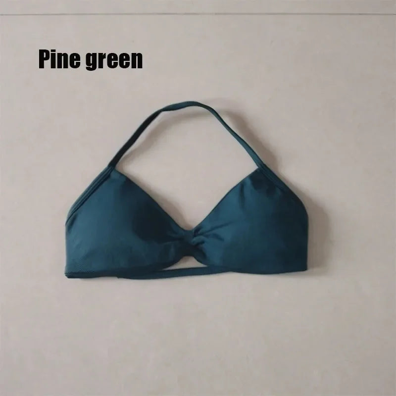A single bikini top cup in a muted pine green color, laid flat against a light beige background with the text 'Pine green' in the upper left corner.
