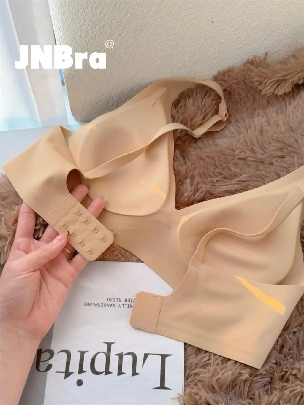 Beige bra on a textured surface with 'JNBra' branding.