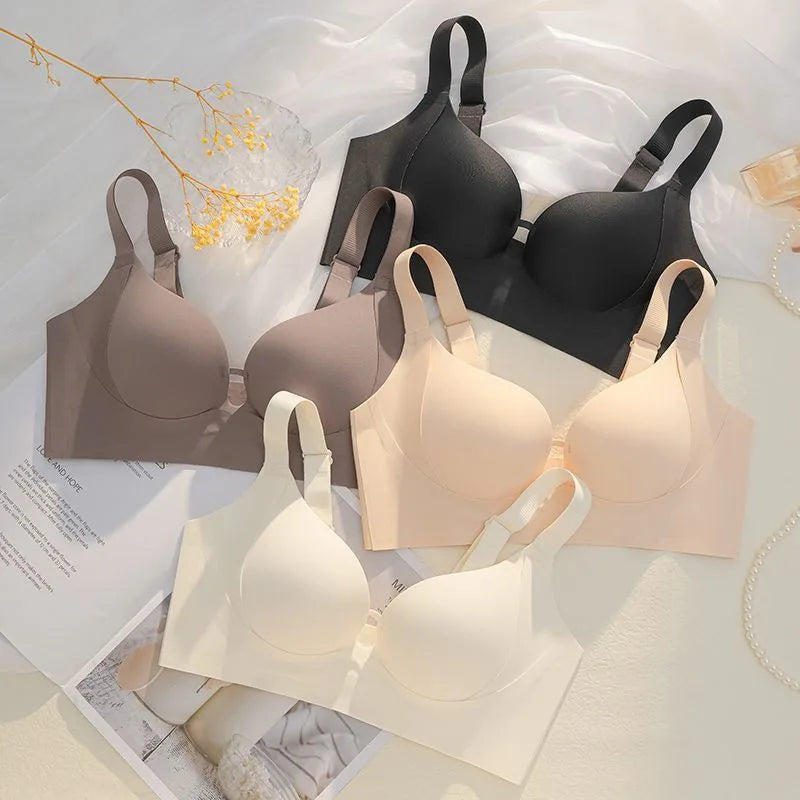 Set of various color bras on a light background