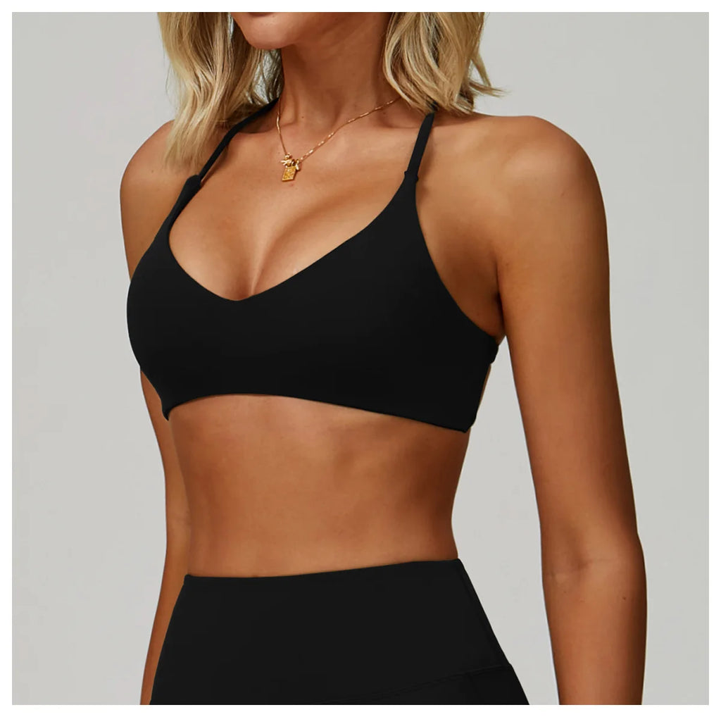 Black sports bra worn by a person on a plain background