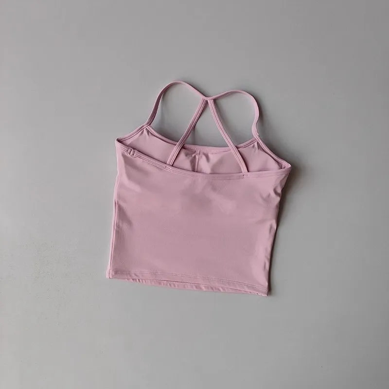 Pink tank top with thin straps on a gray background