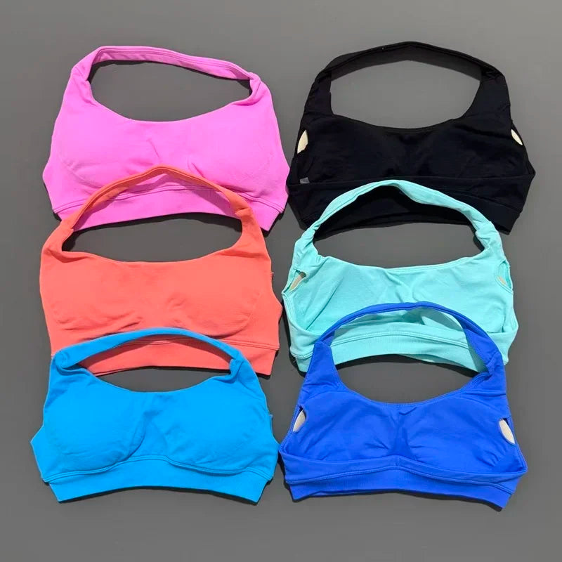 Set of six colorful bras arranged on a gray background