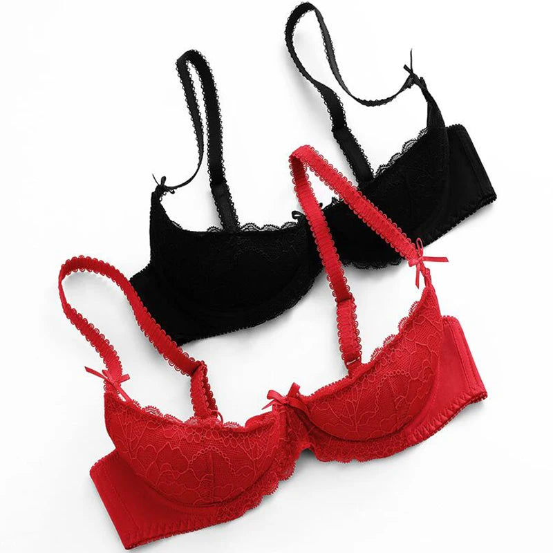 Red and black lace bras on a white background
