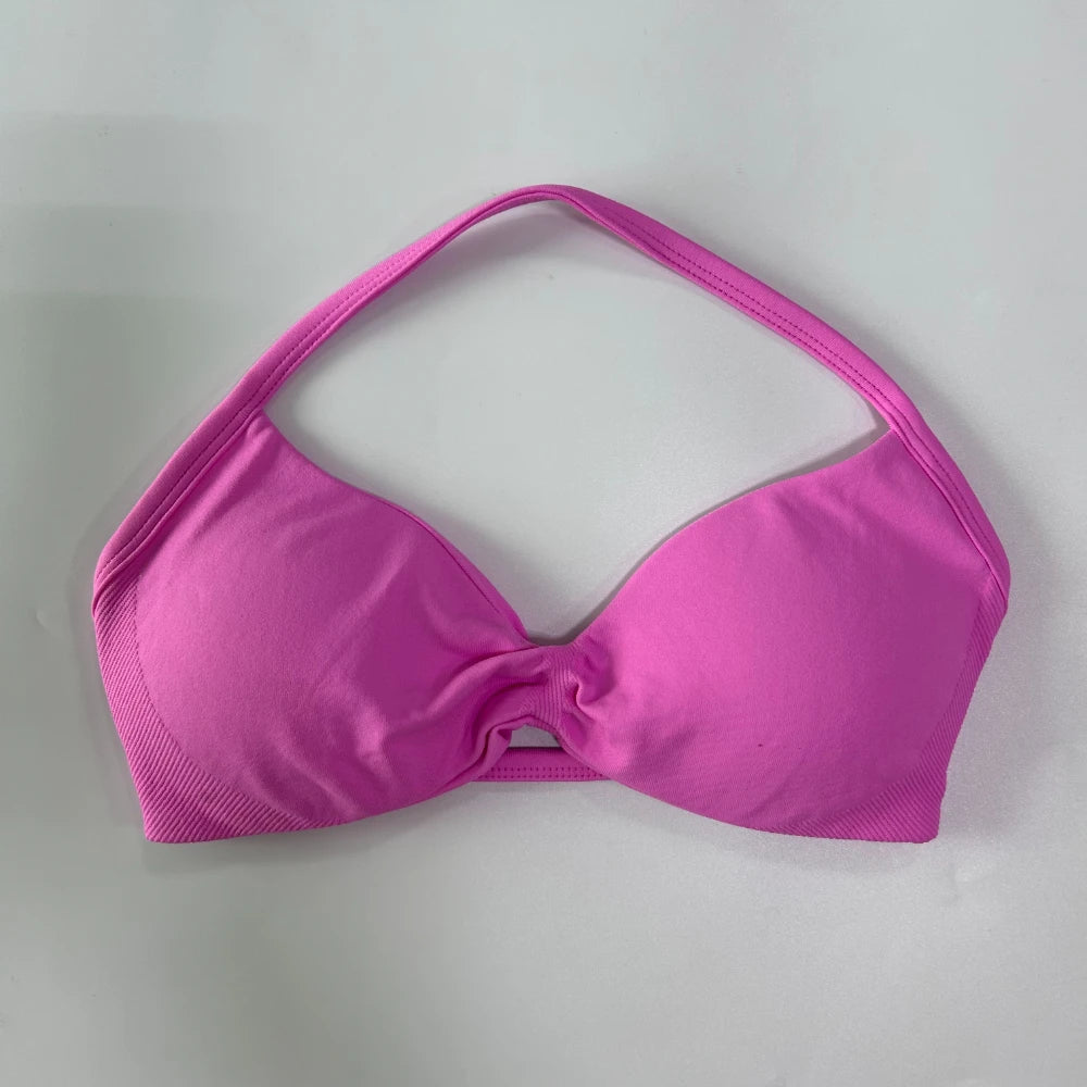 Pink bikini top on a light gray background