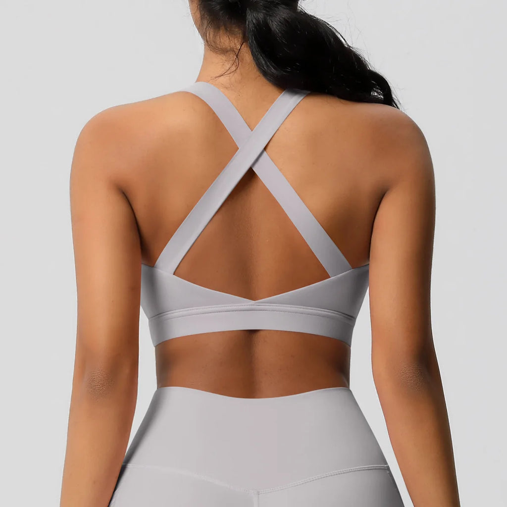 Gray sports bra and leggings on a plain background