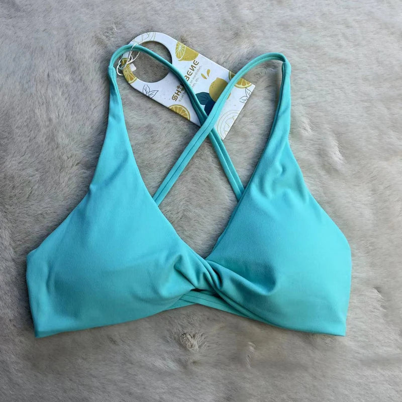 Turquoise bikini top on a fur surface with a tag attached