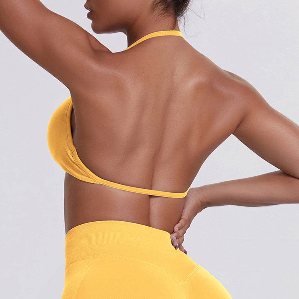 Person wearing a yellow bikini against a light gray background