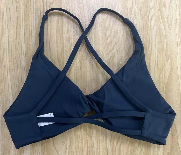 Navy blue bikini top on a wooden surface