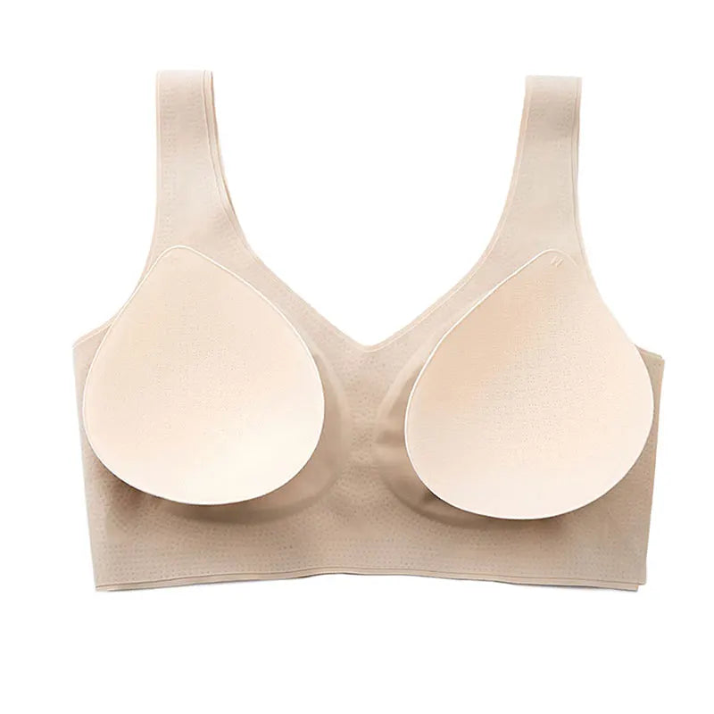 A beige wireless bra with two large, seamless, teardrop-shaped adhesive cup inserts on a solid white background.