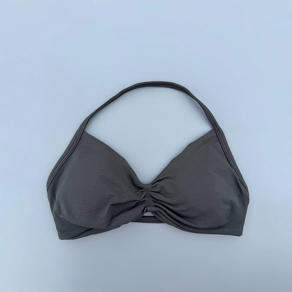 Gray bikini top on a light blue background