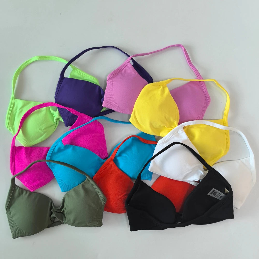 A collection of multi-colored triangle bralette swimwear tops arranged in a fan shape on a light gray background. The colors include lime green, purple, pink, yellow, white, blue, red, and olive green.